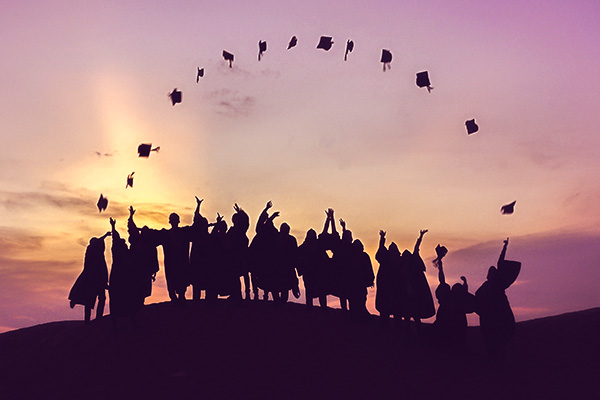 graduates tossing up hats